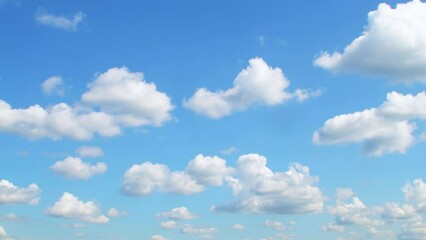 Wall Mural - Blue sky with slowly moving white clouds. Calm, relaxing background.