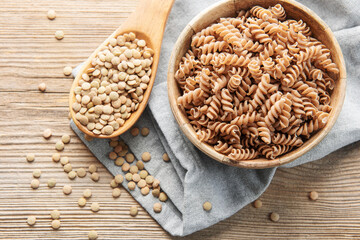 Sticker - Green lentil fusilli pasta on a old wooden background.