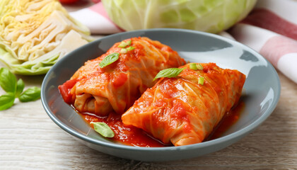 Wall Mural - Delicious stuffed cabbage rolls cooked with homemade tomato sauce on table, closeup