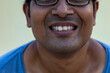 © Rima - Handsome young man isolated over yellow background showing teeth.