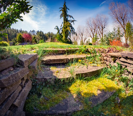 Sticker - Stone staircase in garden. Sunny spring scene of shore of lake. Amazing view of first warm day in city park. Beauty of nature concept background.