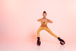 endurance and balance, woman in kangoo jumping shoes exercising on pink background