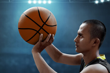 Asian male basketball player shooting a ball