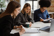 © Drobot Dean - Three young women doing paperwork while sitting in office