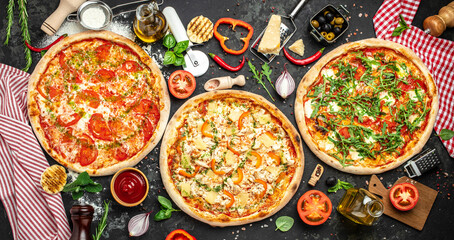 Wall Mural - pizza set on a dark background, Fast food lunch, Long banner format. top view