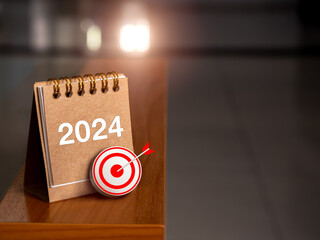 Wall Mural - Happy new year 2024 banner background. 3d target icon with 2024 numbers year on brown small desk calendar cover standing on table edge with sunlight and copy space. Business goal and success concepts.