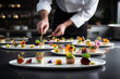 © Maksym - A chef, viewed from behind, arranging a beautifully plated appetizer on a white plate, with various sauces and garnishes scattered around. Generative AI