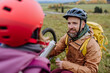 © Halfpoint - Father and daughter resting, having snack during hiking together in autumn mountains.