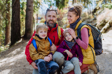 Wall Mural - Happy young family with little children, resting near lake in mountains.