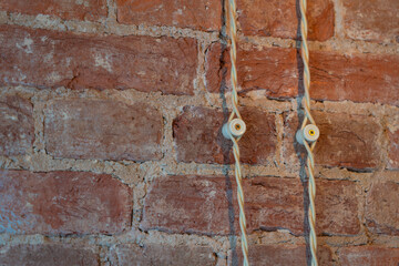 Wall Mural - old red brick wall with electrical wires in insulation, repair