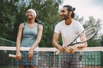 Two tennis players talking on a tennis court before the match