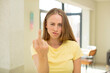 © kues1 - pretty blond woman feeling angry, annoyed, rebellious and aggressive, flipping the middle finger, fighting back