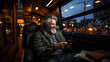 Portrait of senior man using his mobile phone while sitting in a luxury bus at night city.