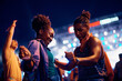 © Drazen - Young black couple dancing while enjoying in summer music festival at night.