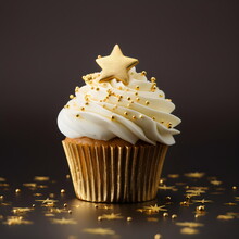 Cupcake With White Frosting And Golden Star Sprinkles Isolated On Plain Brown Studio Background
