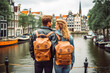 couple traveling in Amsterdam. Happy young travelers exploring in city.