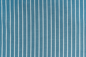 Striped blue white fabric texture background wtih copy space. Shirt fabric, tablecloth textile, garment cloth, upholstery with classic pattern with lines. Backdrop, wallpaper, background.