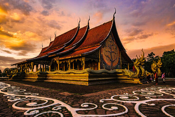 Wall Mural - Church of Wat Phra That Phu Prao during evening light at sunset around glow, Ubon Ratchathani Province, Thailand