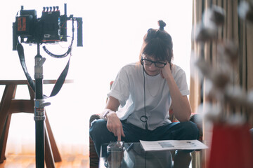 Wall Mural - The director is a woman at work on the set. The director works with a group or with a playback while filming a movie