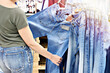 Woman chooses jeans in store
