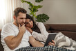 © ivanko80 - Couple using digital tablet at home