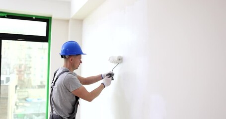 Wall Mural - Painter painting wall with paint roller. Wall and ceiling painting