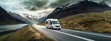 An Rv On Mountain Terrain Traveling Down The Road,