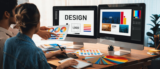 Poster - Graphic designer work on computer laptop and with graphic drawing pen while brainstorming unique design with professional graphic team in modern digital studio workplace. Panorama shot. Scrutinize