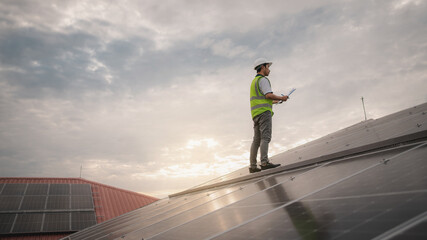 Wall Mural - a service engineer checks a solar cell that is mounted on the roof to see if there is a damaged comp