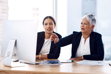 Mentor, training or business women with computer talking, speaking or planning a project in office. Technology, teamwork collaboration or senior manager explaining to an intern for digital coaching