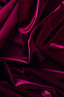Purple creasy velvet fabric background texture. Empty dark red fabric background of soft and smooth textile material.