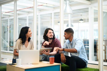 Poster - Working together to exceed the expectations of everyone. Shot of a group of businesspeople using a digital tablet together in an office.
