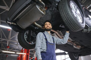 Aufkleber - Portrait of a mechanic repairing a lifted car