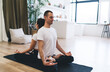 © BullRun - Partner yoga Padmasana exercise on mat