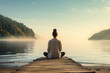 © SnapVault - Young woman meditating on a wooden pier on the edge of a lake to improve overall well-being.lotus pose