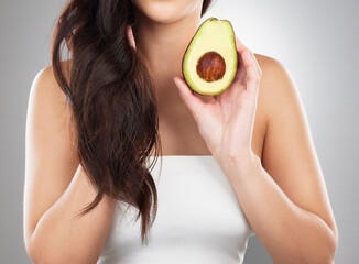 Sticker - Hair care, wellness and woman with an avocado in a studio for a natural, organic or health mask. Self care, beauty and closeup of a female model with a fruit for a hair treatment by a gray background