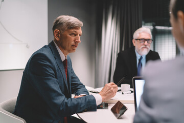 Wall Mural - Serious male entrepreneur listening to colleagues