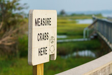 Measure Crabs Here Sign Along A Boardwalk At Assateague
