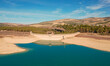 Drought in the reservoir. Very low water reserves due to the effects of climate change. Aerial view. Empty reservoir. Granada. Spain.