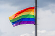 © fotomolka - Celebration of pride month, Colourful rainbow flag hanging waving in the air on white grey background, Symbol of Gay, Lesbian, Bisexual and Transgender, LGBTQ community, Worldwide social movements.
