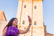 © Sangiao_Photography - Alcala de Henares. Latin mid-woman travel holiday lifestyle portrait happy with smartphone in Spain