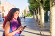 © Sangiao_Photography - Alcala de Henares. Latin mid-woman travel holiday lifestyle portrait happy with smartphone in Spain