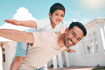 Poster - Happy, airplane and portrait of a father with his child in the outdoor garden at their family home. Playful, smile and young dad carrying his boy kid on his back while bonding and playing together.