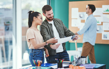 Poster - Its about leaving a mark with their brand. Shot of two young designers having a discussion in an office.
