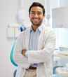 © Ismail/peopleimages.com - Dentist, portrait and man with arms crossed for healthcare service, dental hospital or insurance in consultation office. Happy asian person or doctor with teeth, oral or hygiene health in clinic