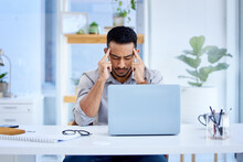 Mental Health, Businessman With A Headache And Laptop On His Desk In Office At Workplace. Anxiety Or Depression, Mistake Or Problem And Male Person Frustrated Or Stress Sitting At His Workstation