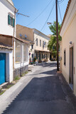 Fototapeta Uliczki - Street with old buildings in Lakones village, Corfu, Greece