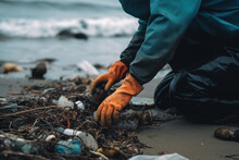 Generative AI Illustration Of Side View Of Anonymous Person In Protective Clothes With Orange Gloves Sitting On Shore Of The Beach While Picking Up Trash Against Blurred Background