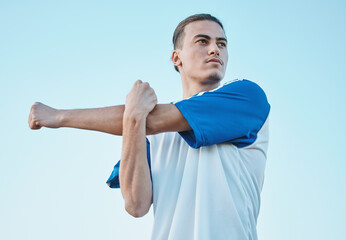 Poster - Soccer, stretching and a sports man on a blue sky background in preparation for a game or competition. Fitness, health and warm up with a young male athlete getting ready for training or practice