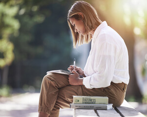 Sticker - Woman, writing and student with books at park outdoor to study for future in business management. Studying, learning or knowledge of a young female person in nature with notebook for school education